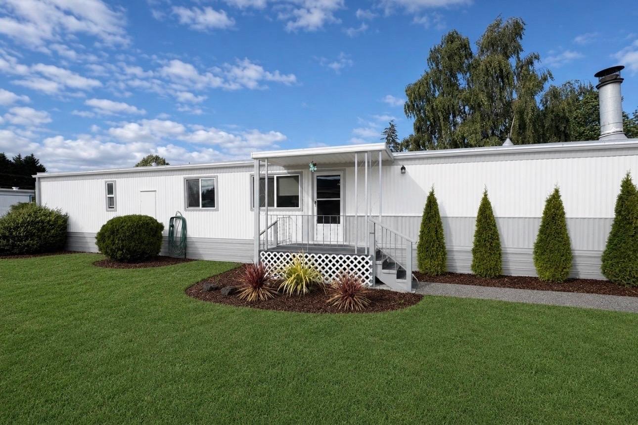 The same property after landscaping, with a finished lawn and fresh beds