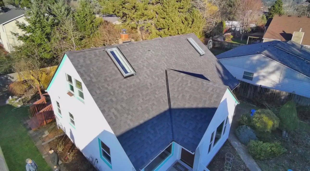Finished roof with skylights on a white house