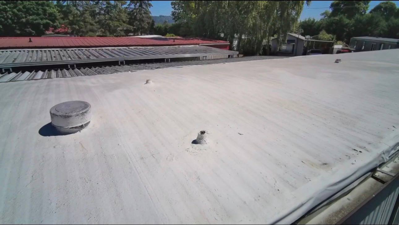 The old worn roof coating before tear off