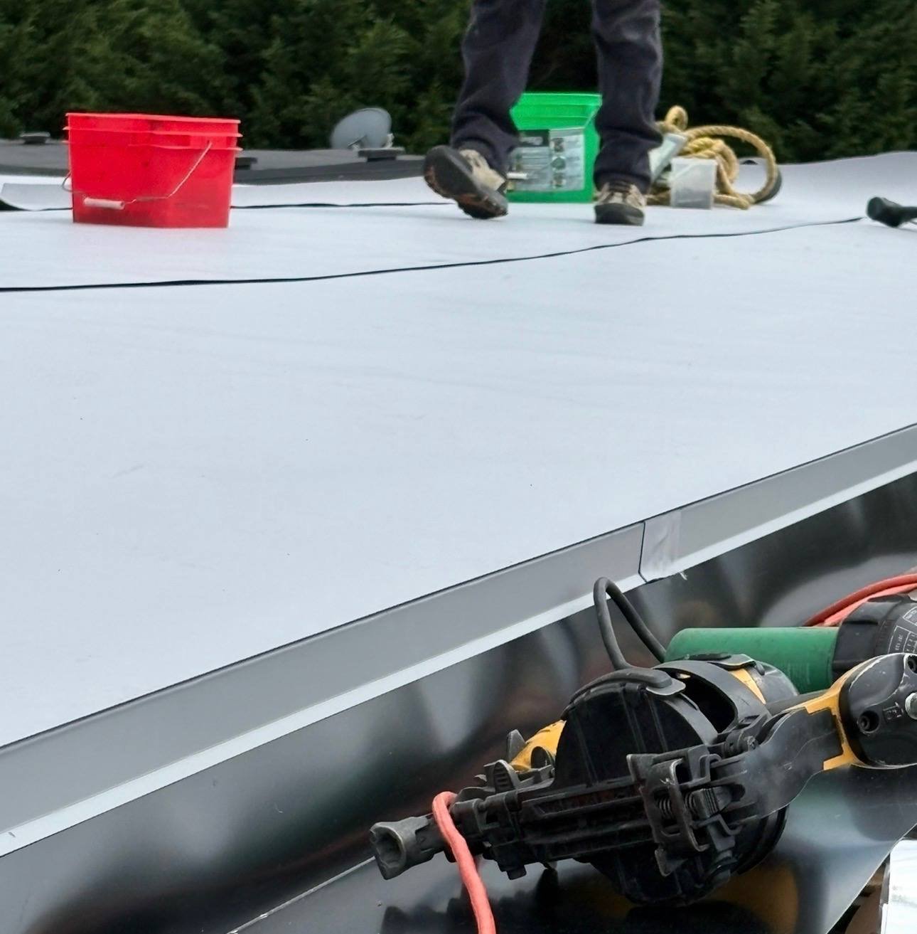 The crew welding the membrane at the roof edge