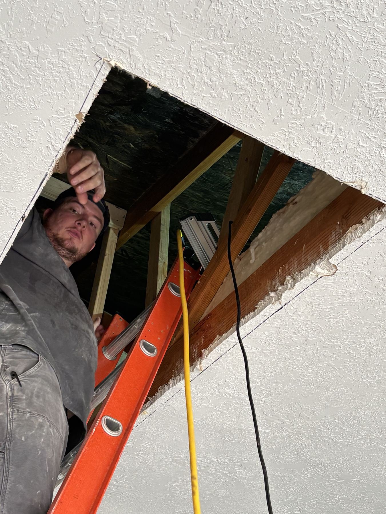 The skylight opening being cut through the ceiling from inside