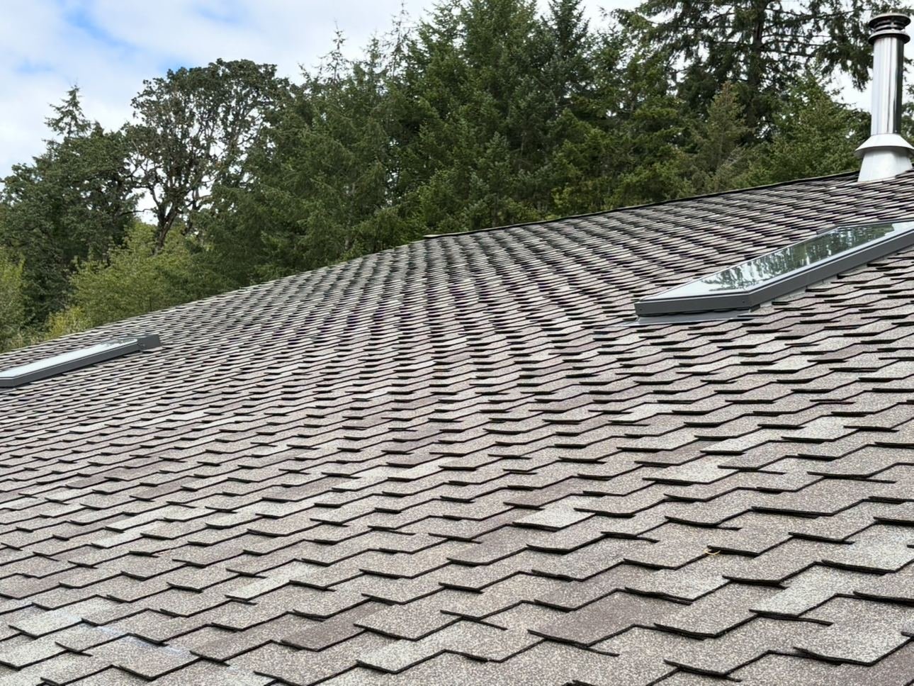 The finished shingle field with a roof vent