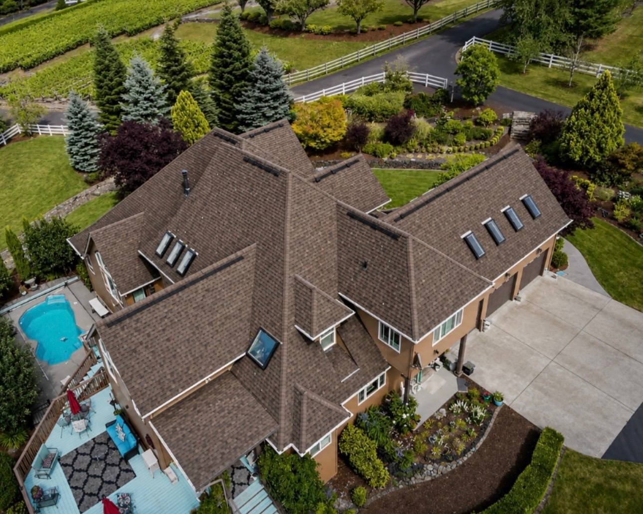 Completed roof replacement on a large brick home